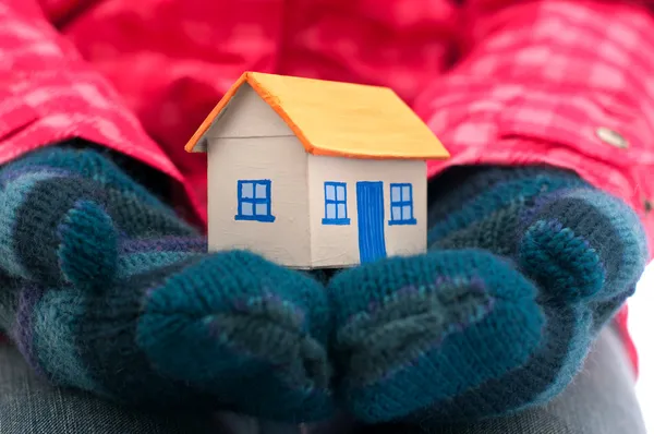 Дом держит женщину в зимних перчатках — стоковое фото